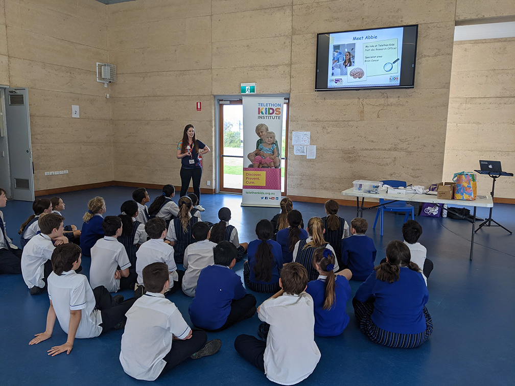 researcher presenting at a school