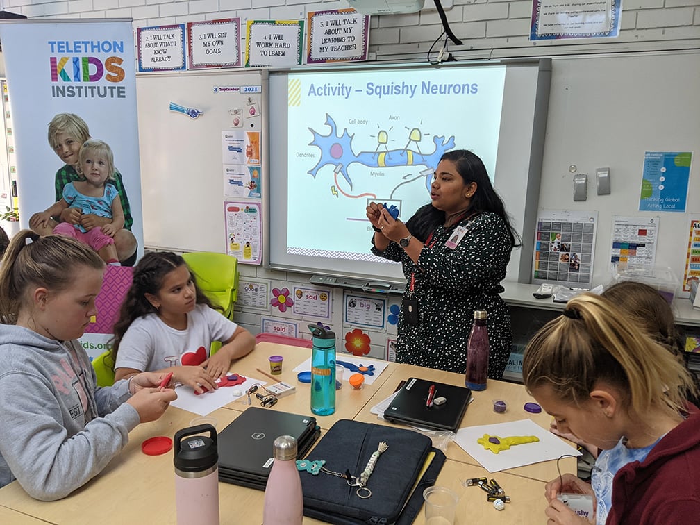 researcher presenting at a school