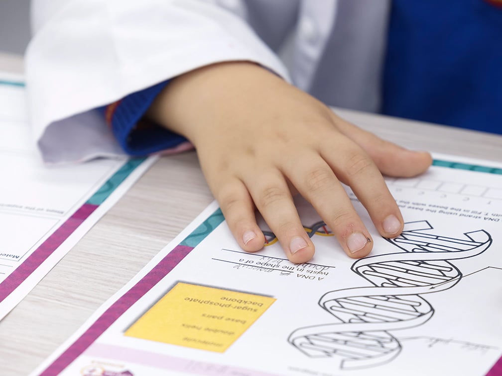 Child writing on a piece of paper