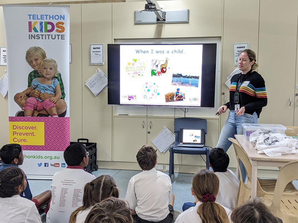 researcher presenting at a school